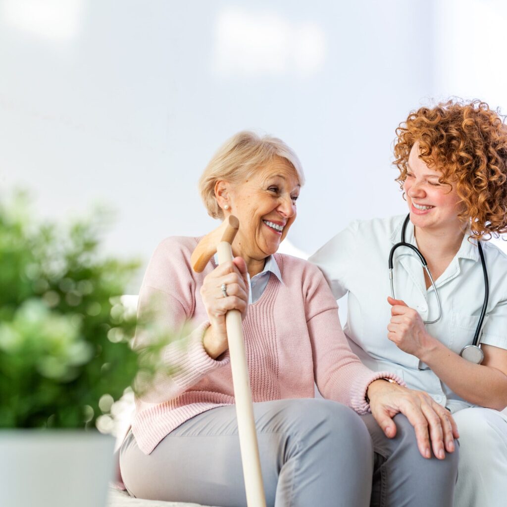 carer sitting in garden with senior person